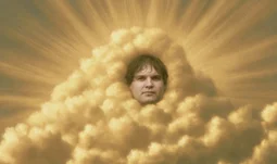 a man's face in a golden cloud 
