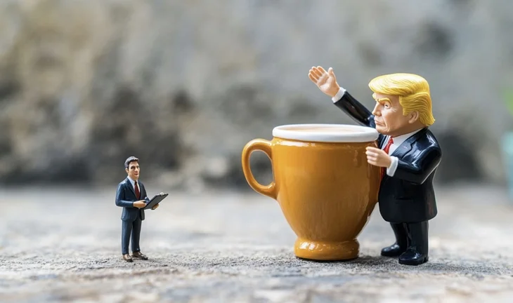 A small plastic Trump waving his hand 