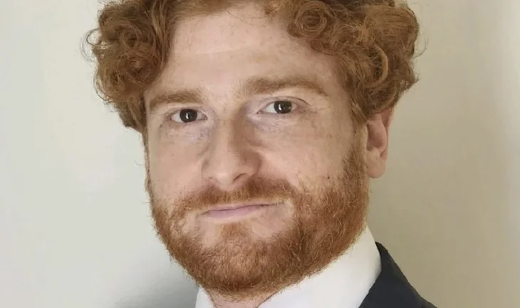 a bearded man with ginger hair 