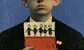 a banker holding a red wallet with a stick drawing of his children coming out of it